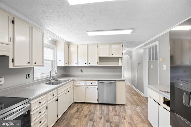 kitchen featuring a textured ceiling, stainless steel appliances, crown molding, sink, and wood-type flooring