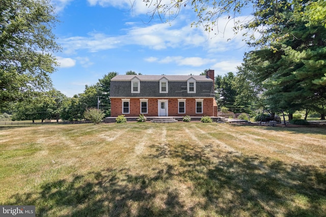 cape cod home with a front lawn