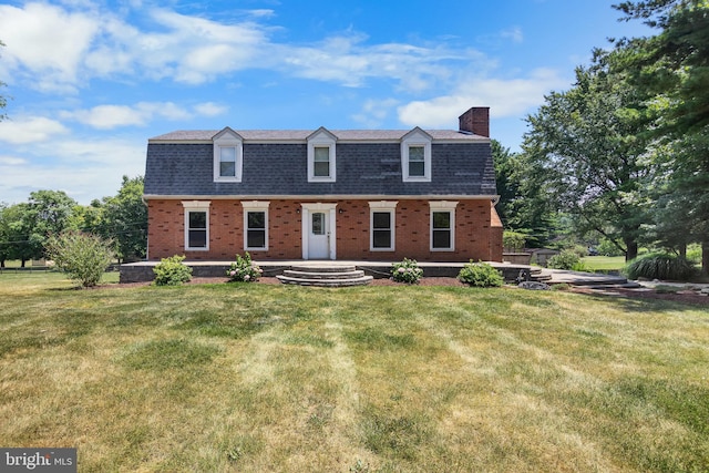 new england style home with a front yard