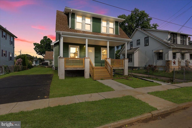 bungalow-style house featuring a porch and a lawn