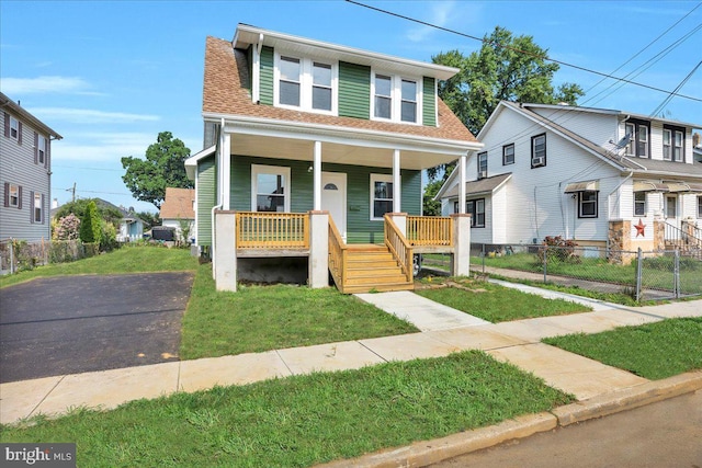 view of front of home with a porch and a front lawn