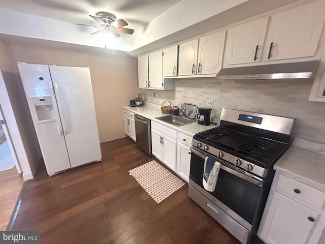 kitchen featuring appliances with stainless steel finishes, dark hardwood / wood-style flooring, white cabinets, and sink