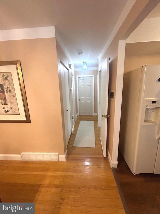 hall with hardwood / wood-style flooring