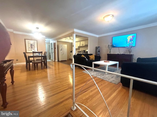 living room featuring light hardwood / wood-style flooring and ornamental molding