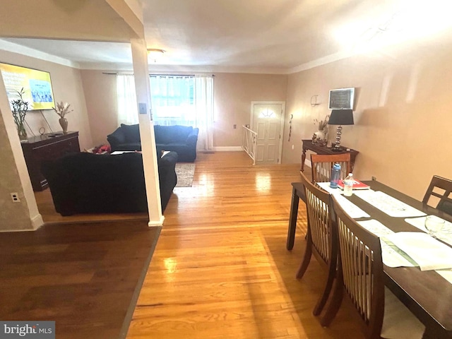 dining area featuring light hardwood / wood-style floors and ornamental molding