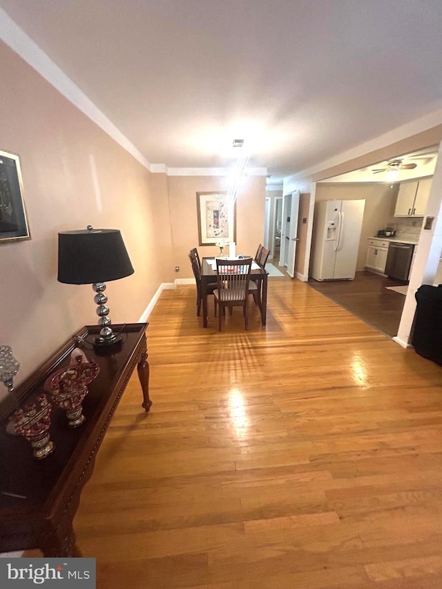 dining area with ornamental molding and hardwood / wood-style flooring