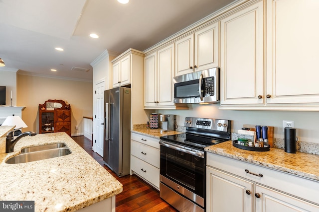 kitchen featuring light stone countertops, appliances with stainless steel finishes, dark wood-type flooring, crown molding, and sink