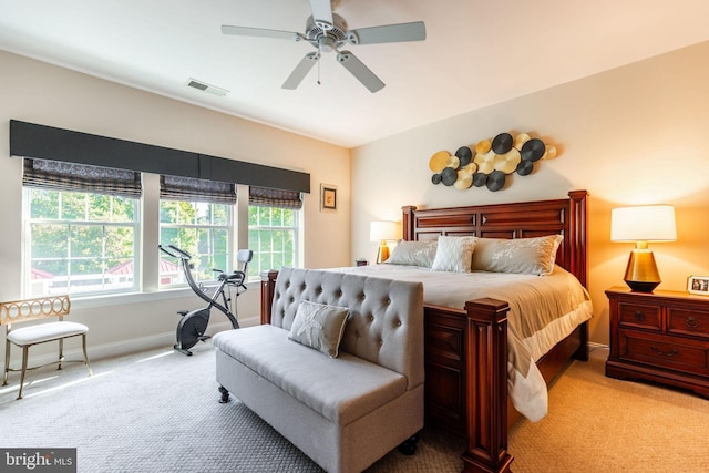 bedroom with ceiling fan and light carpet