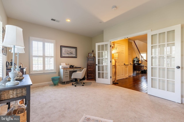 carpeted office space featuring french doors