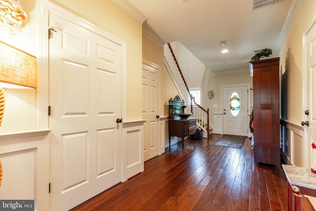 foyer with dark hardwood / wood-style floors and ornamental molding