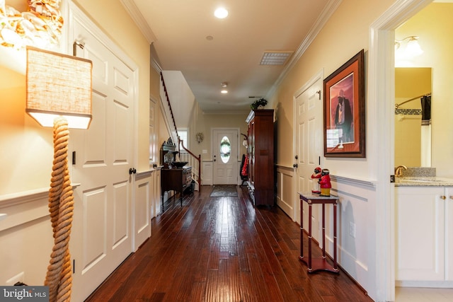 hall featuring crown molding, sink, and dark hardwood / wood-style floors