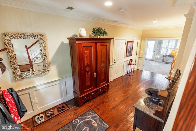 hall with crown molding and dark hardwood / wood-style floors