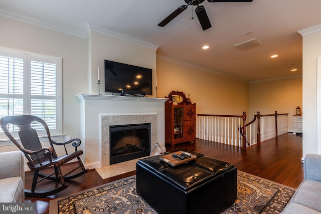 living room with a fireplace, ceiling fan, hardwood / wood-style floors, and ornamental molding