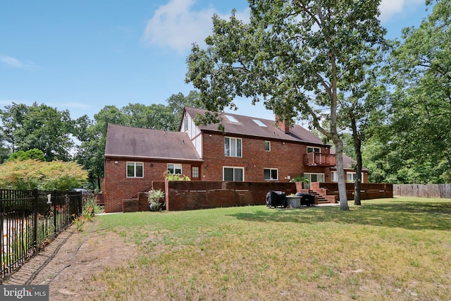 back of house with a wooden deck and a yard