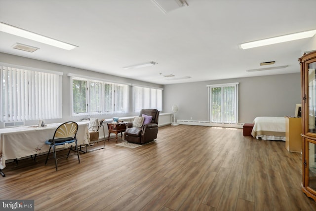 sitting room featuring hardwood / wood-style floors and a baseboard radiator