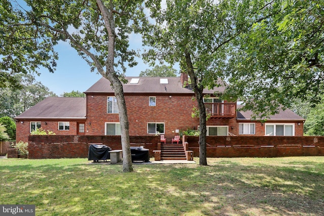 rear view of house with a lawn