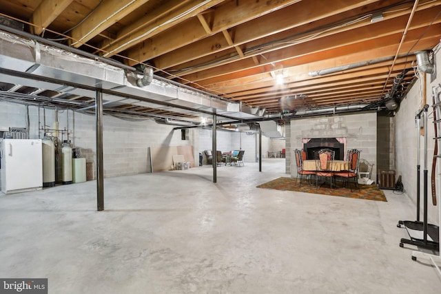 basement featuring a brick fireplace