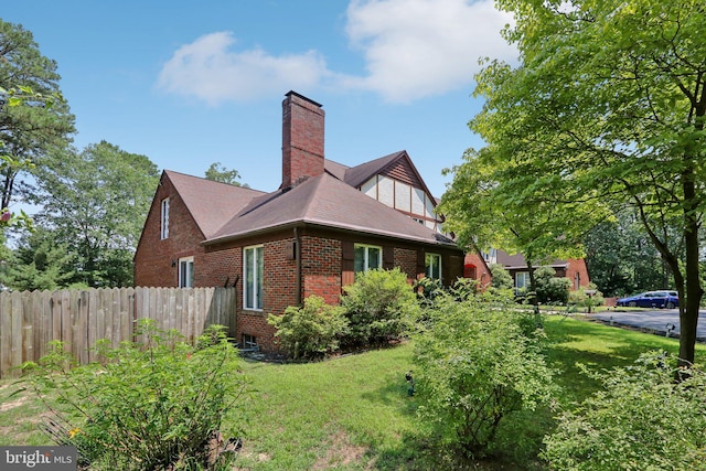 view of side of property with a yard