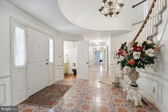 foyer with light tile patterned floors and a notable chandelier