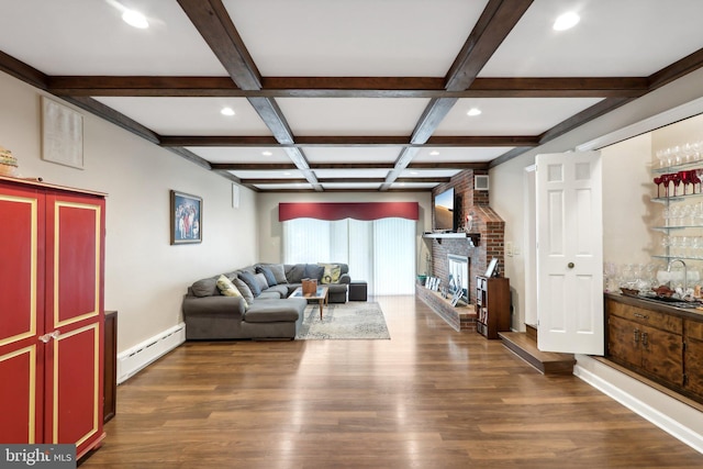 living room with dark wood-type flooring, a baseboard heating unit, beamed ceiling, a brick fireplace, and coffered ceiling