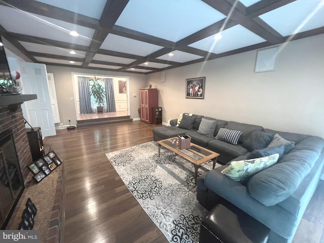 living room featuring a brick fireplace, dark hardwood / wood-style flooring, beam ceiling, and coffered ceiling