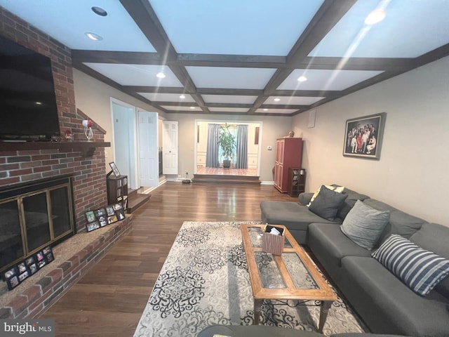 living room with beam ceiling, dark hardwood / wood-style flooring, a fireplace, and coffered ceiling