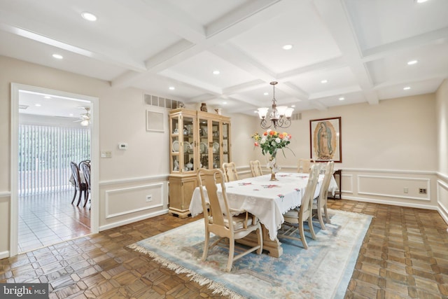 dining space with beam ceiling, ceiling fan with notable chandelier, and coffered ceiling