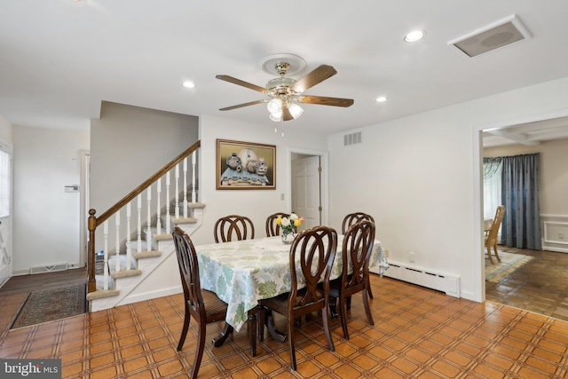 dining space featuring baseboard heating and ceiling fan