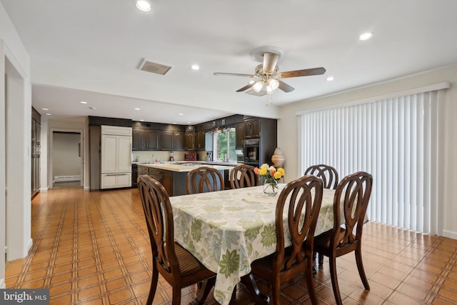 dining area with ceiling fan and a baseboard radiator