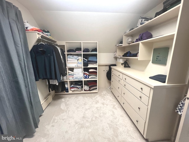 walk in closet with light carpet and a baseboard heating unit