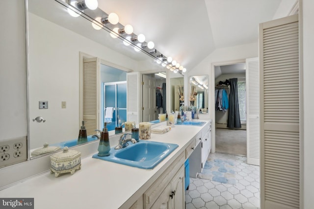 bathroom featuring baseboard heating, vanity, vaulted ceiling, and tile patterned floors