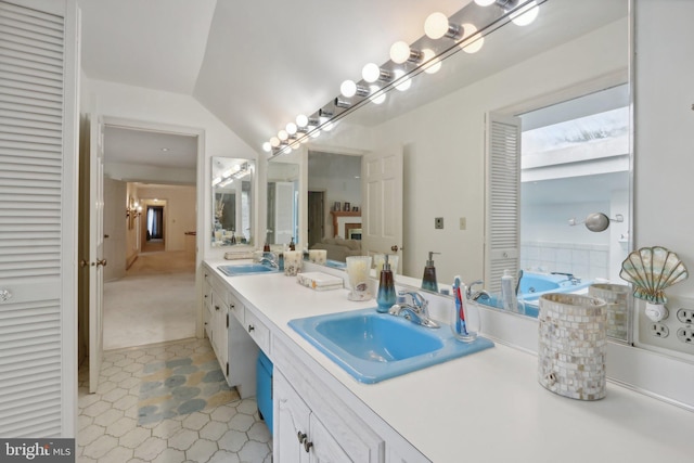 bathroom featuring vanity and vaulted ceiling