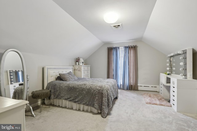 bedroom with lofted ceiling, a baseboard heating unit, and carpet