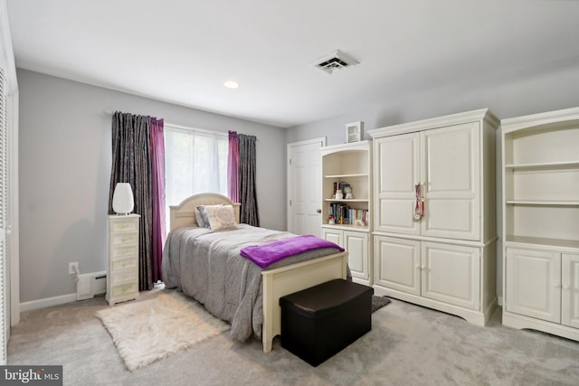 bedroom featuring light carpet