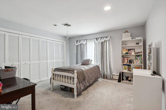 bedroom featuring light colored carpet, a closet, and a baseboard heating unit