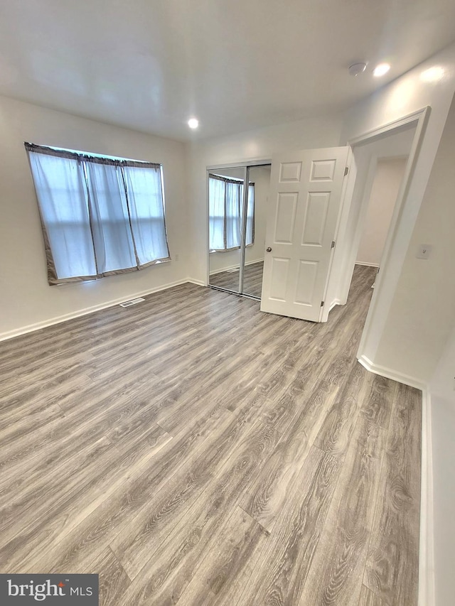 empty room with hardwood / wood-style flooring