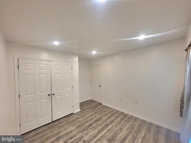 unfurnished bedroom with a closet and wood-type flooring