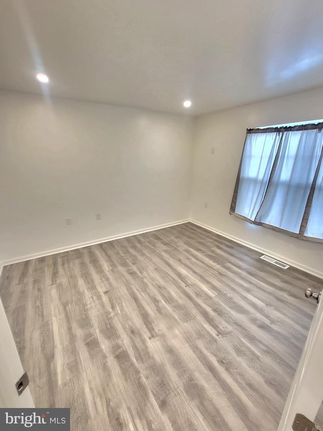 empty room featuring hardwood / wood-style flooring