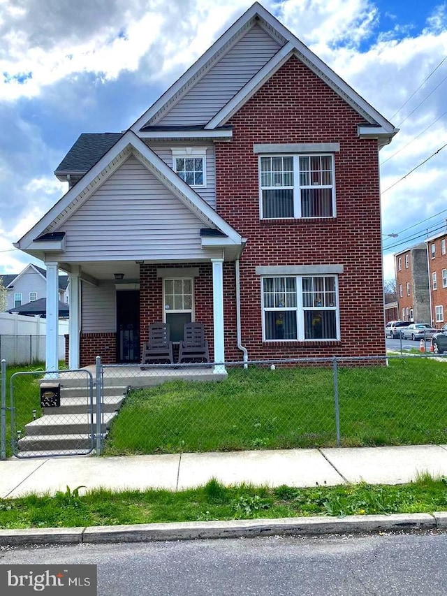 view of front facade with a front yard and covered porch