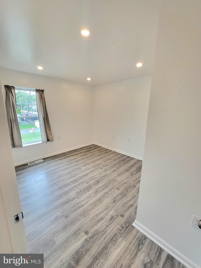 spare room with hardwood / wood-style flooring