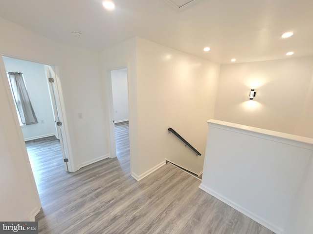 hallway with hardwood / wood-style floors