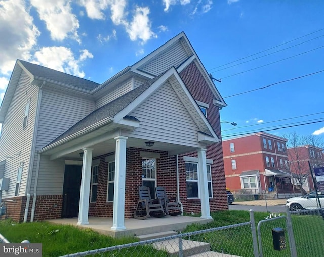 view of front of property with covered porch and a front yard