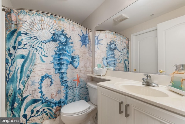 bathroom with toilet and vanity