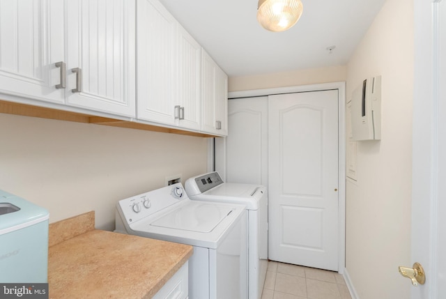 laundry area with washer and dryer, cabinets, light tile patterned floors, and electric panel