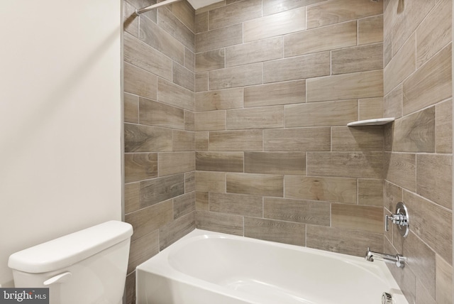 bathroom with tiled shower / bath combo and toilet