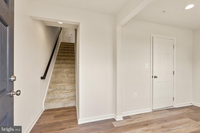 staircase featuring wood-type flooring