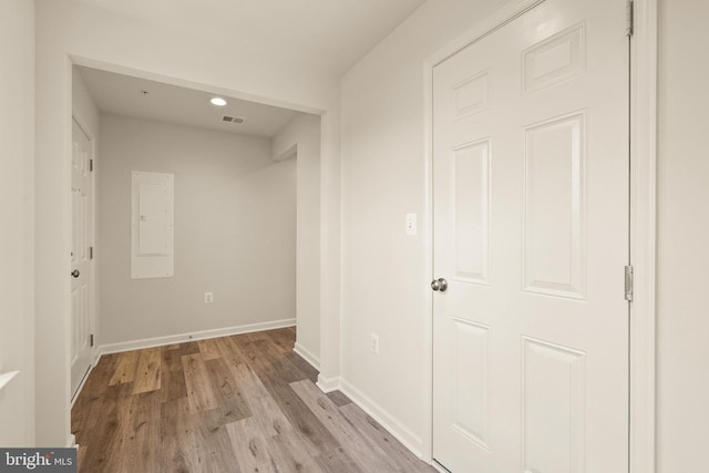 hall with electric panel and light hardwood / wood-style floors