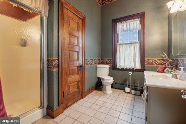 bathroom with baseboard heating, a shower with door, vanity, and tile patterned flooring