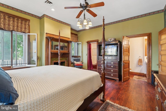 bedroom featuring ceiling fan, dark hardwood / wood-style flooring, and crown molding