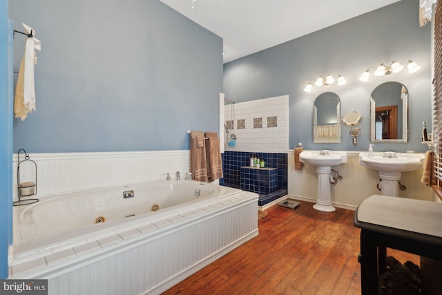 bathroom with a bathing tub, wood-type flooring, and sink